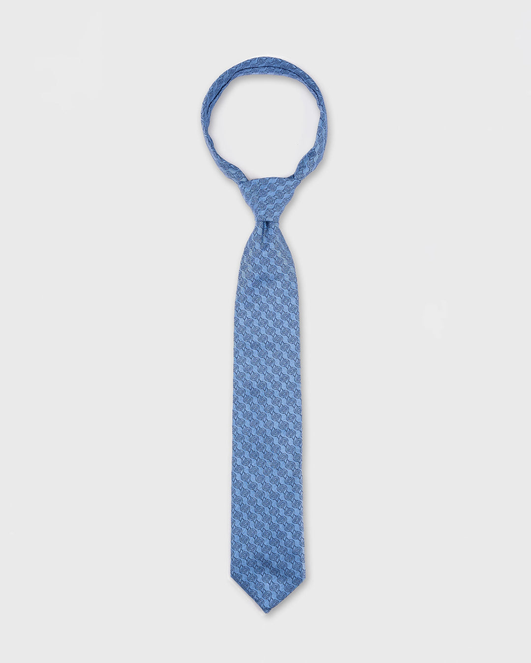 Blue patterned tie on a white background