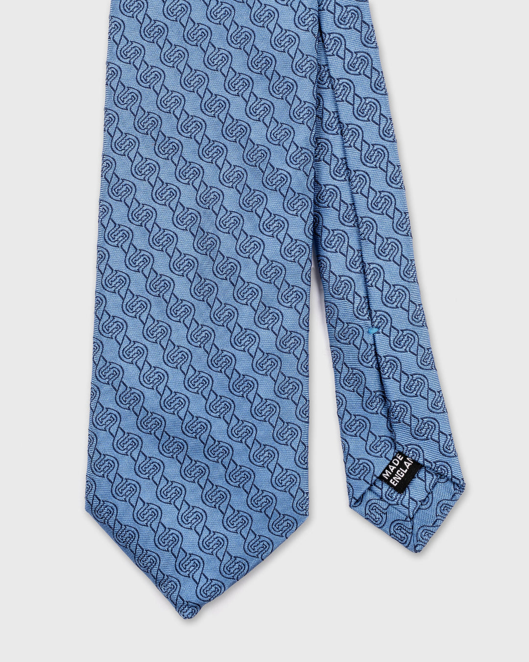 Blue patterned tie on a white background