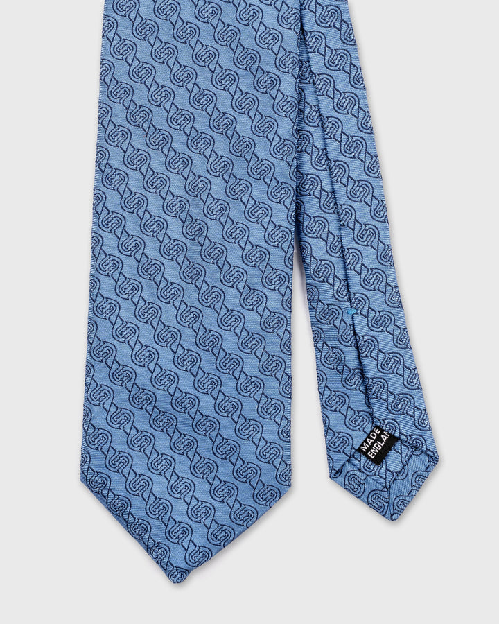 Blue patterned tie on a white background