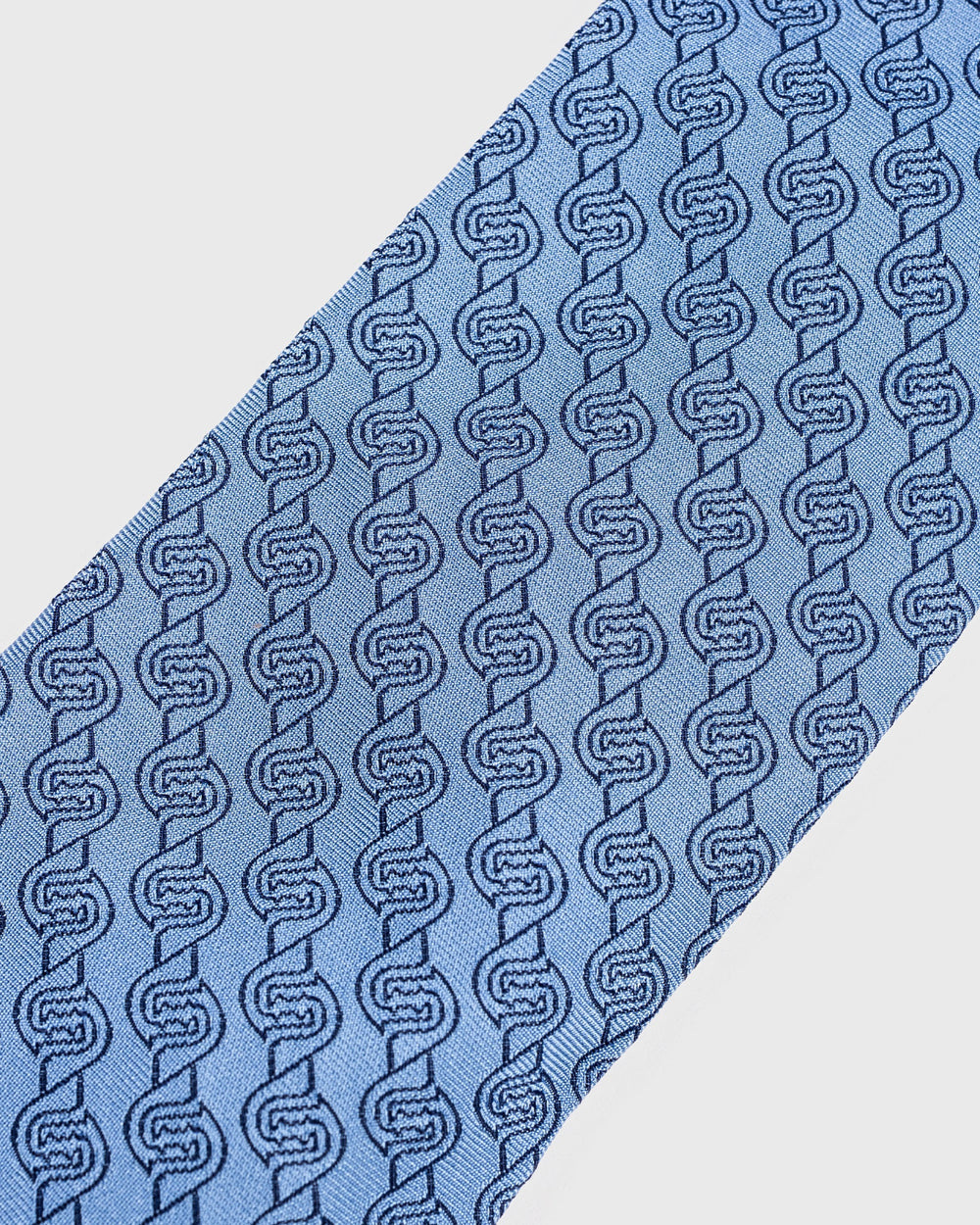 Blue tie with a geometric pattern on a white background