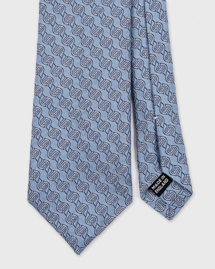 Blue tie with a pattern on a white background