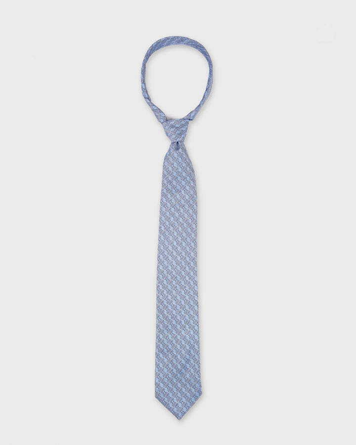 Blue patterned tie on a white background